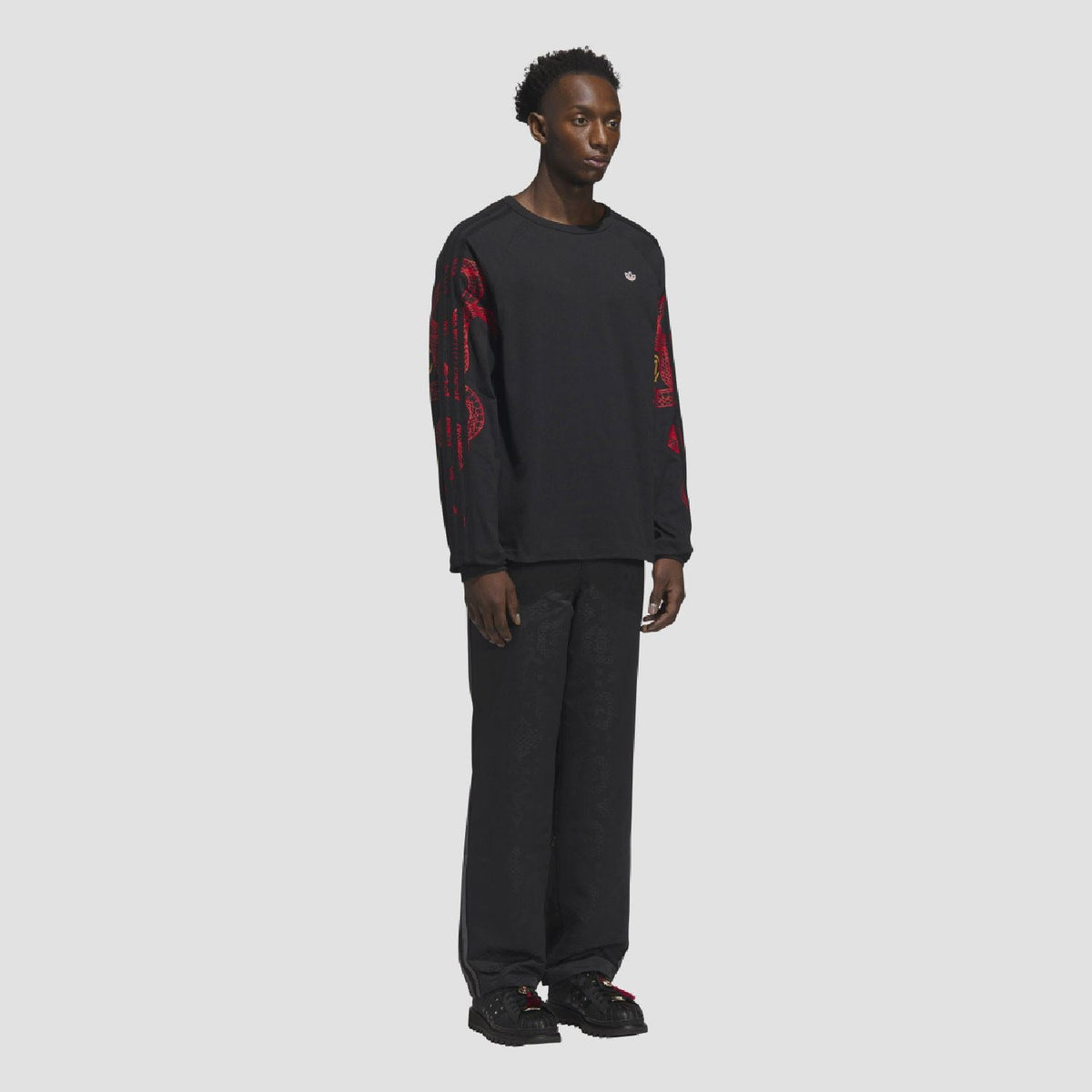 adidas Originals CLOT LNY long sleeve T-shirt with graphic design, black fabric, and branding on the front.