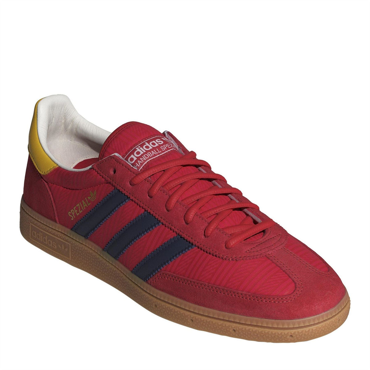 Red low-top trainers with navy stripes, yellow heel detail and white interior lining
