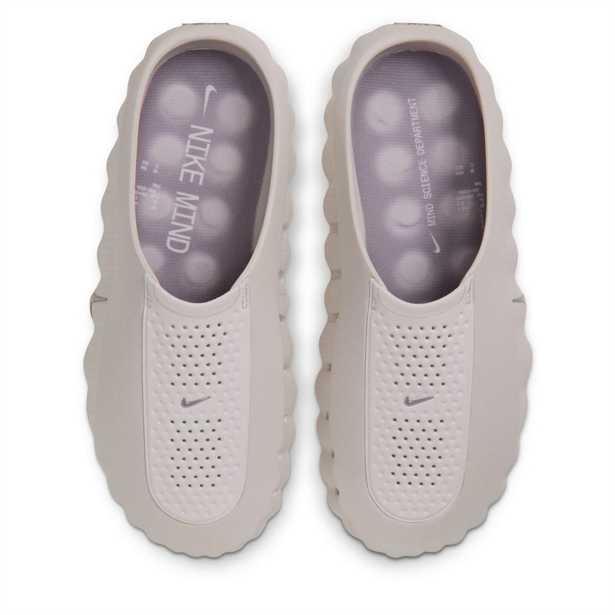 Pale white Nike slide sandals with perforated upper and Nike logo on insole