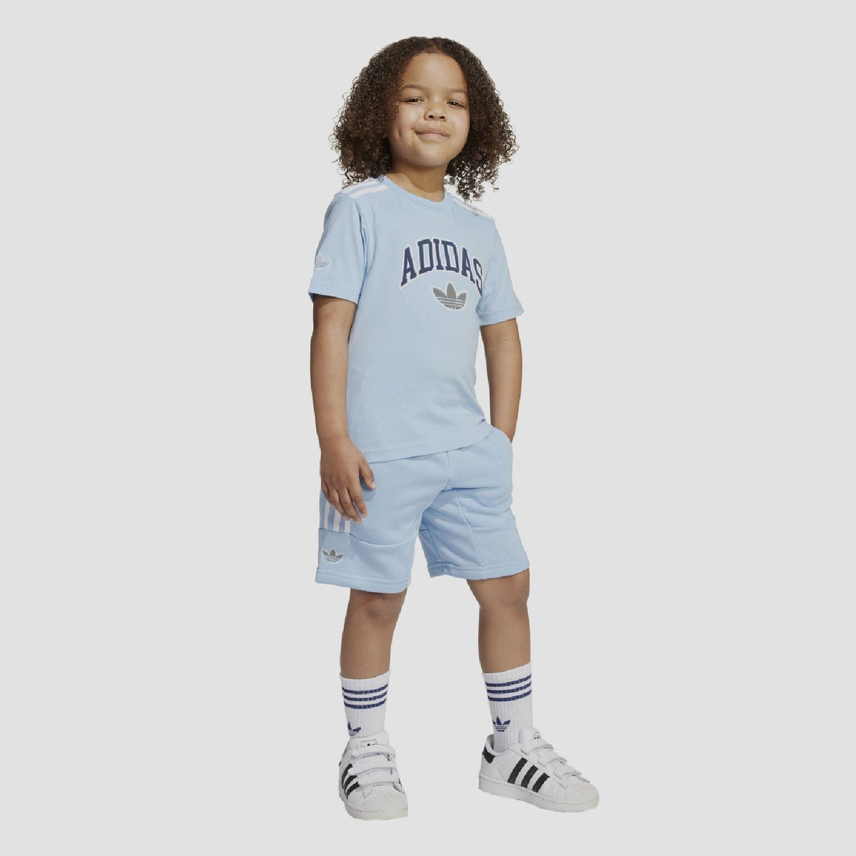 adidas Originals juniors T-shirt and shorts set for ages 8-16, featuring the brand's logo and casual athletic style.