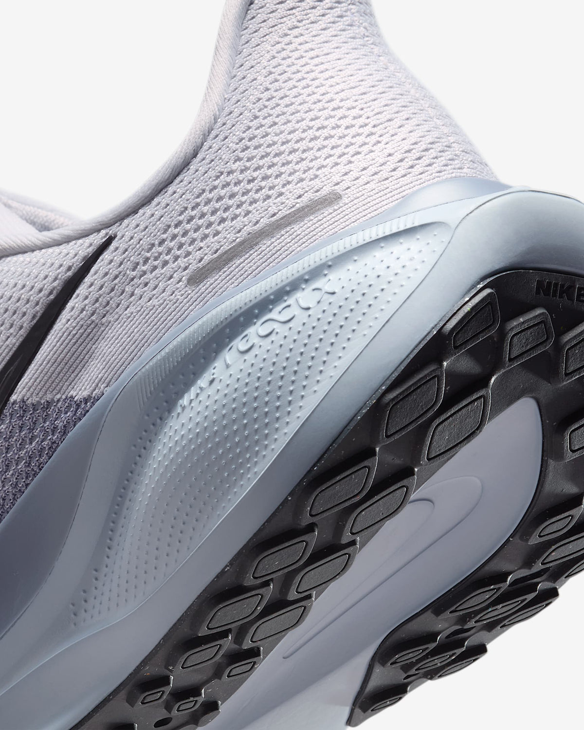 Close-up of light gray shoe side and outsole with Air Zoom branding and traction