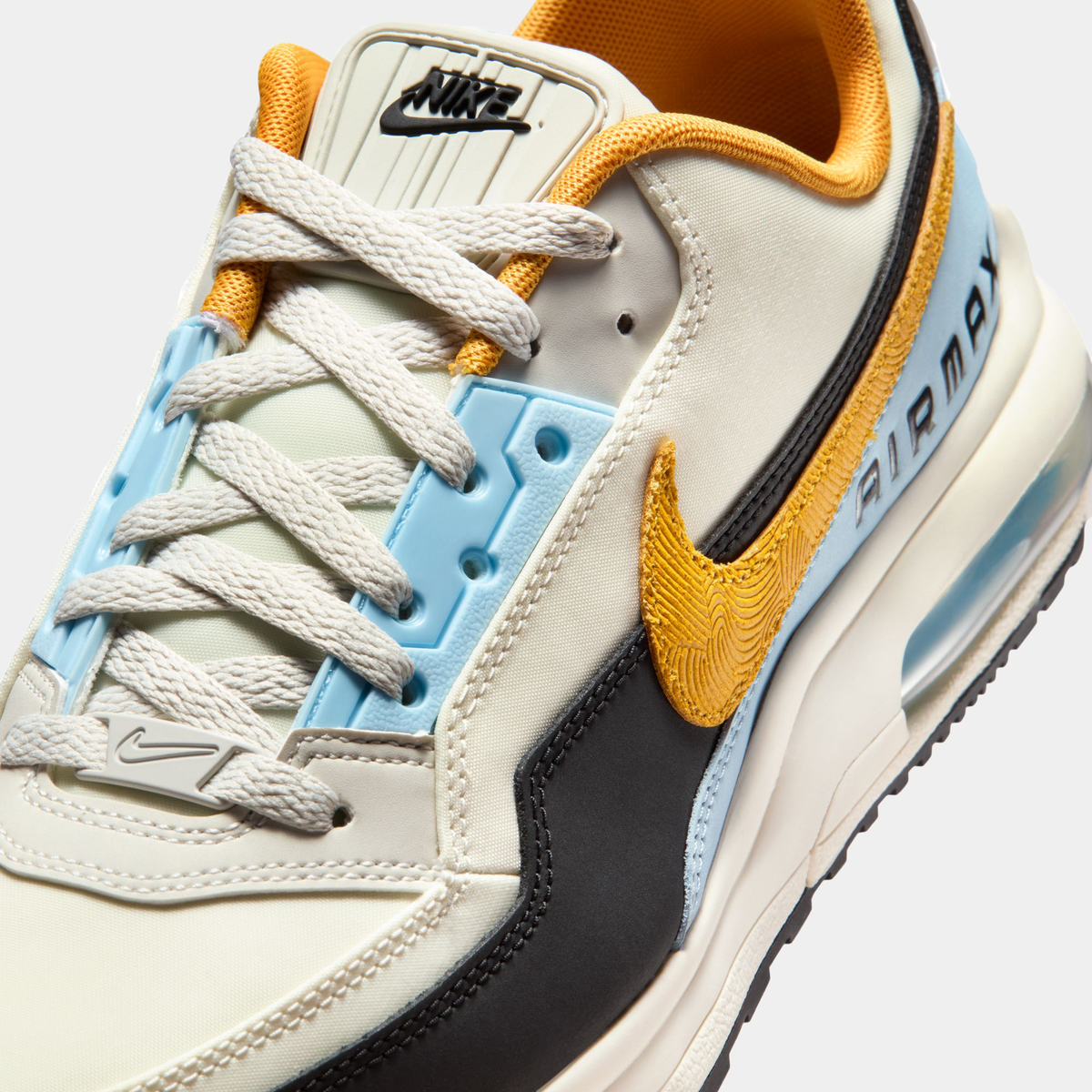 Air Max LTD 3 sneakers close-up of lace-up upper in cream, blue, and black