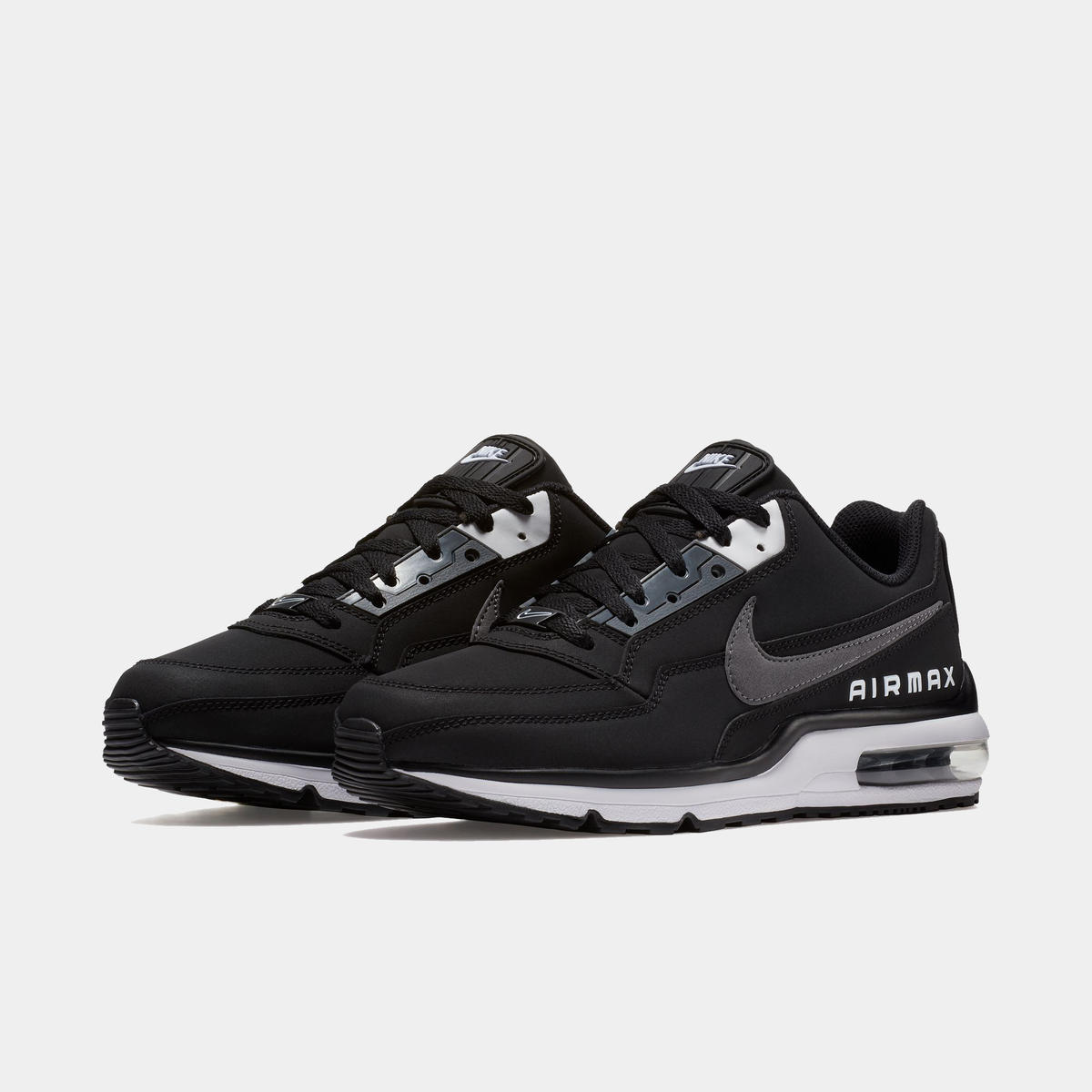 Black Nike Air Max sneakers pair, side profile with gray Swoosh and Air window