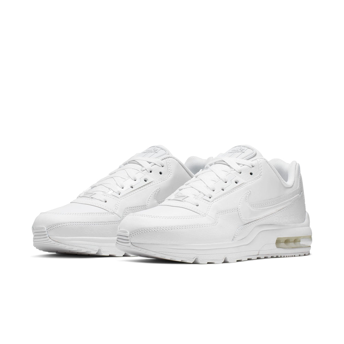 White Nike Air Max sneakers with lace-up front and clear Air unit