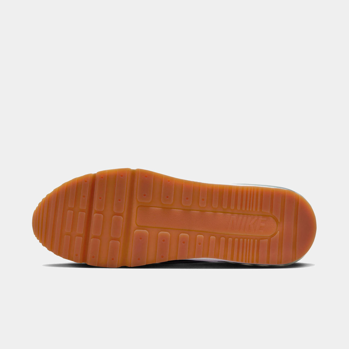 Orange rubber outsole of Nike Air Max sneakers with traction tread and heel logo