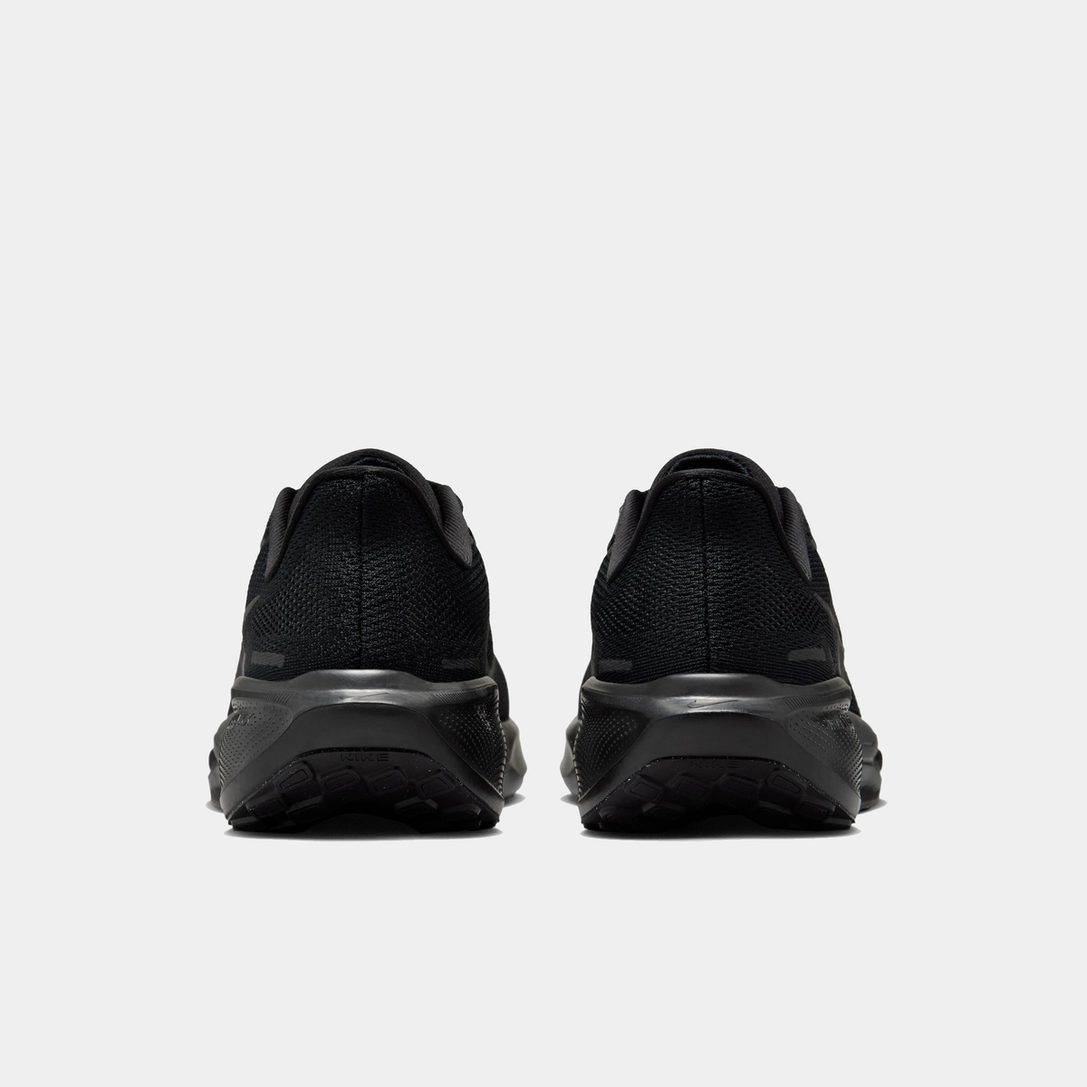 Black running shoe heel view with sculpted foam midsole and rear traction pods