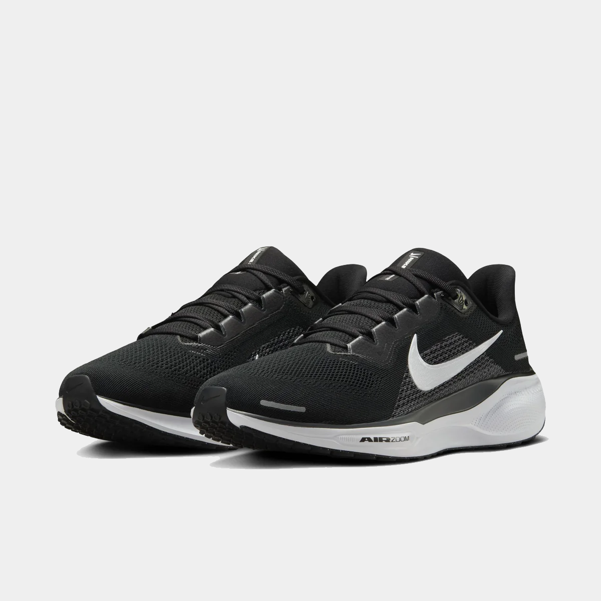 Pair of black running shoes with white trim, lace-up mesh upper