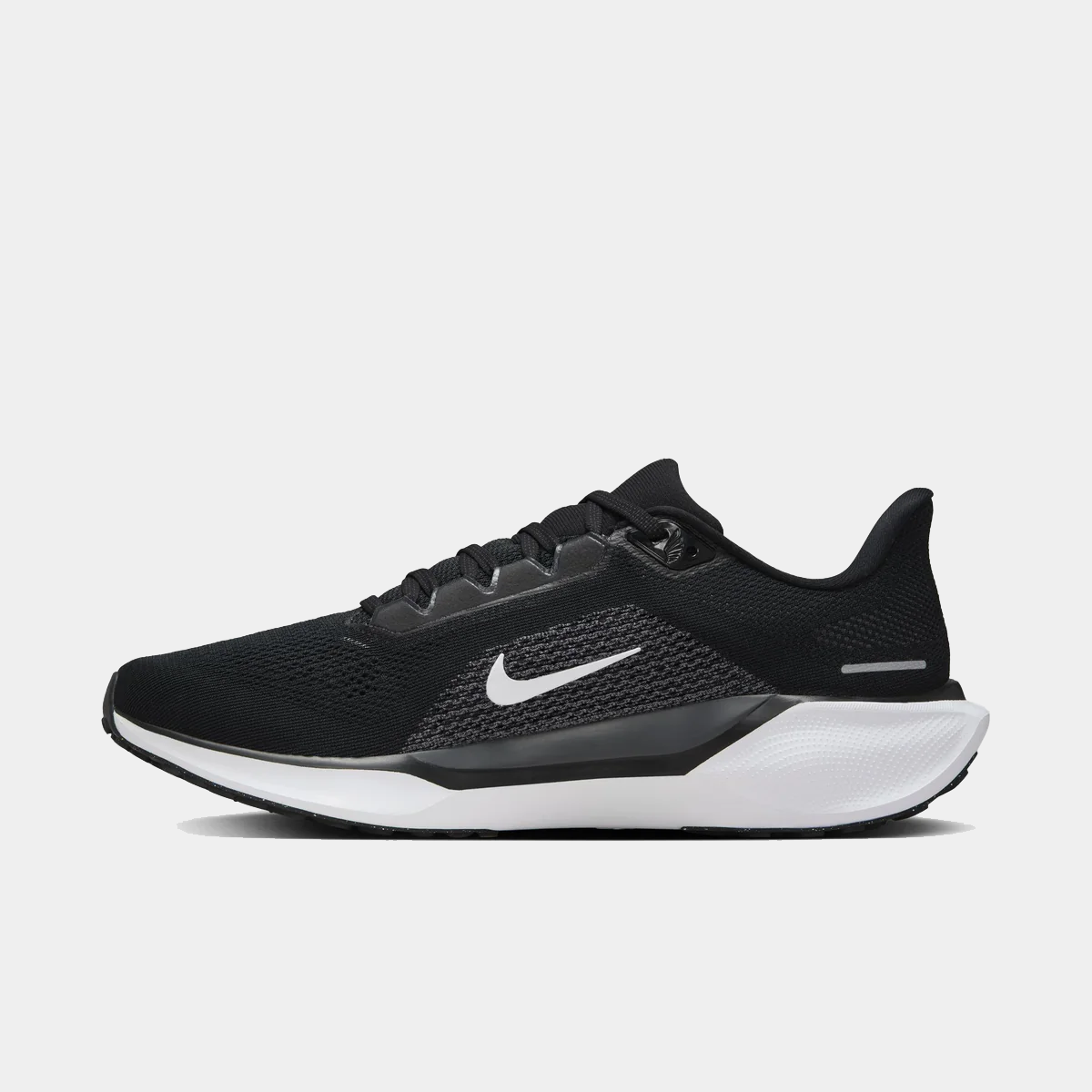 Black running shoe with white swoosh and white midsole, side profile
