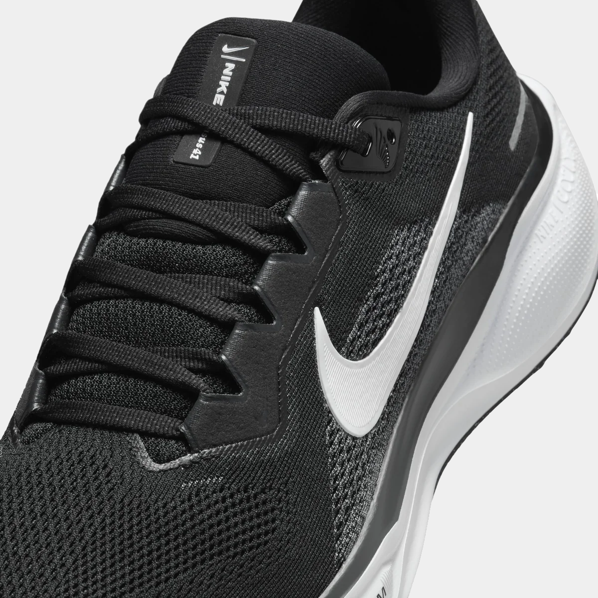 Black running sneaker with mesh upper, lace-up front, Nike swoosh and heel Zoom unit