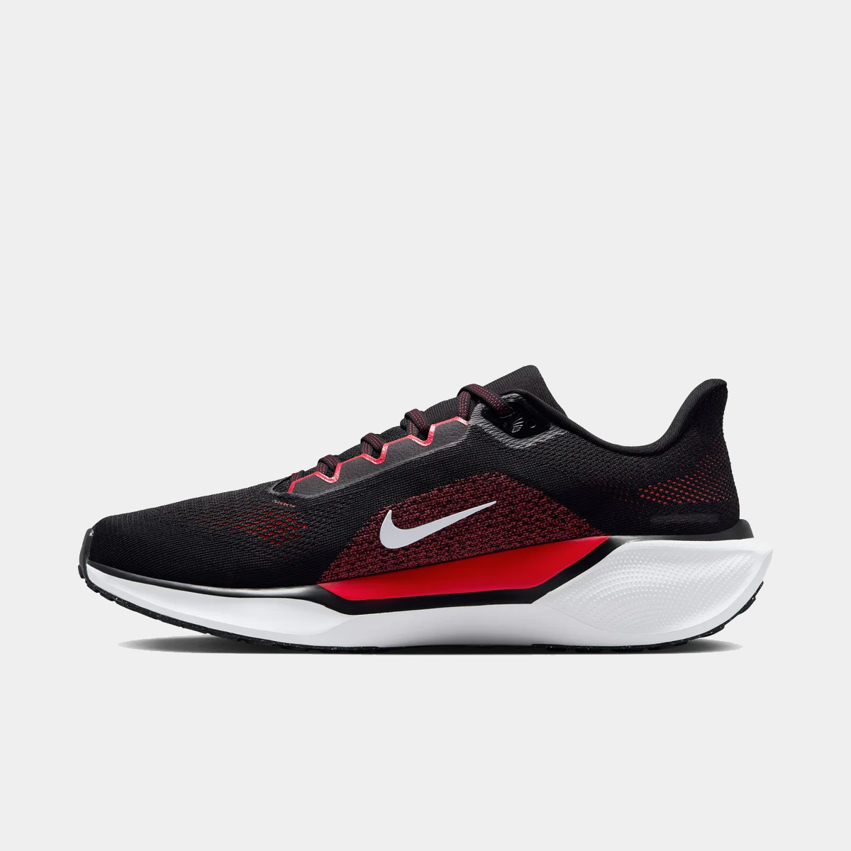 Black and red running shoe with lace-up upper, swoosh logo, and white midsole