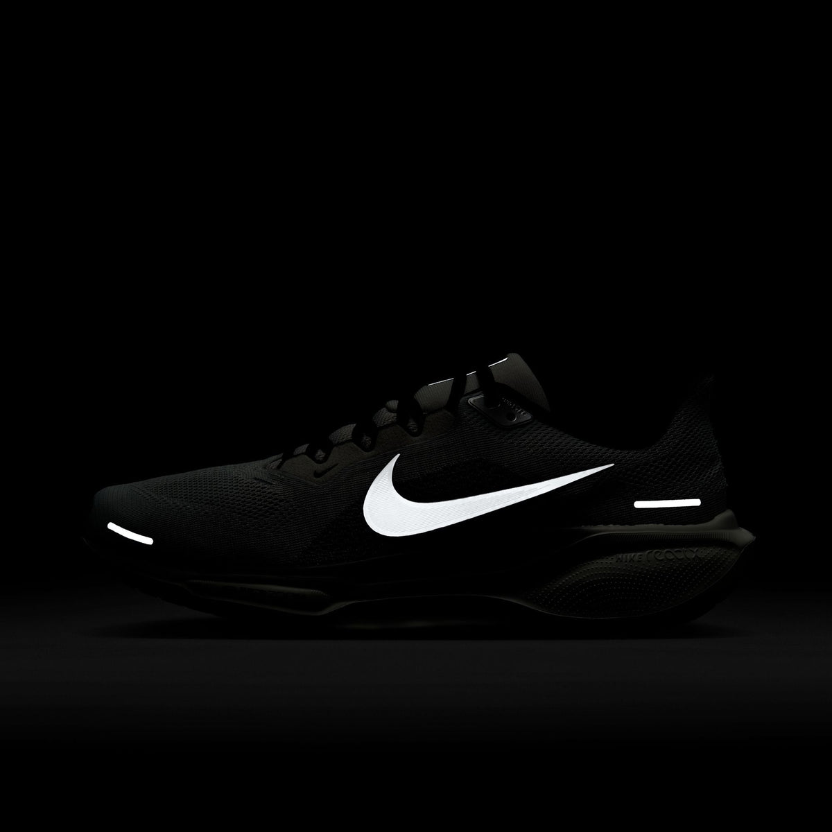 Black running shoes with white Nike swoosh and low-profile cushioned sole