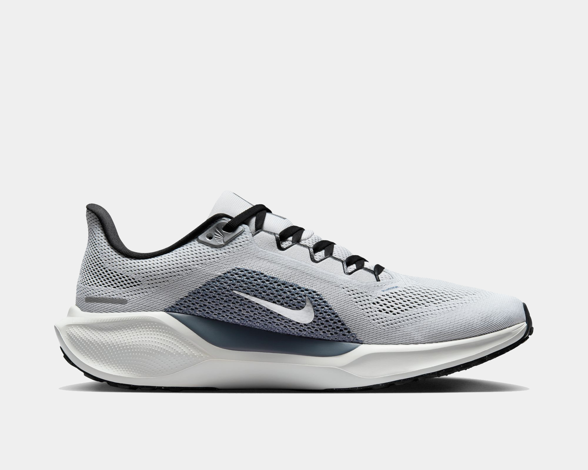 Light gray running shoe with navy swoosh, black laces, and white cushioned midsole