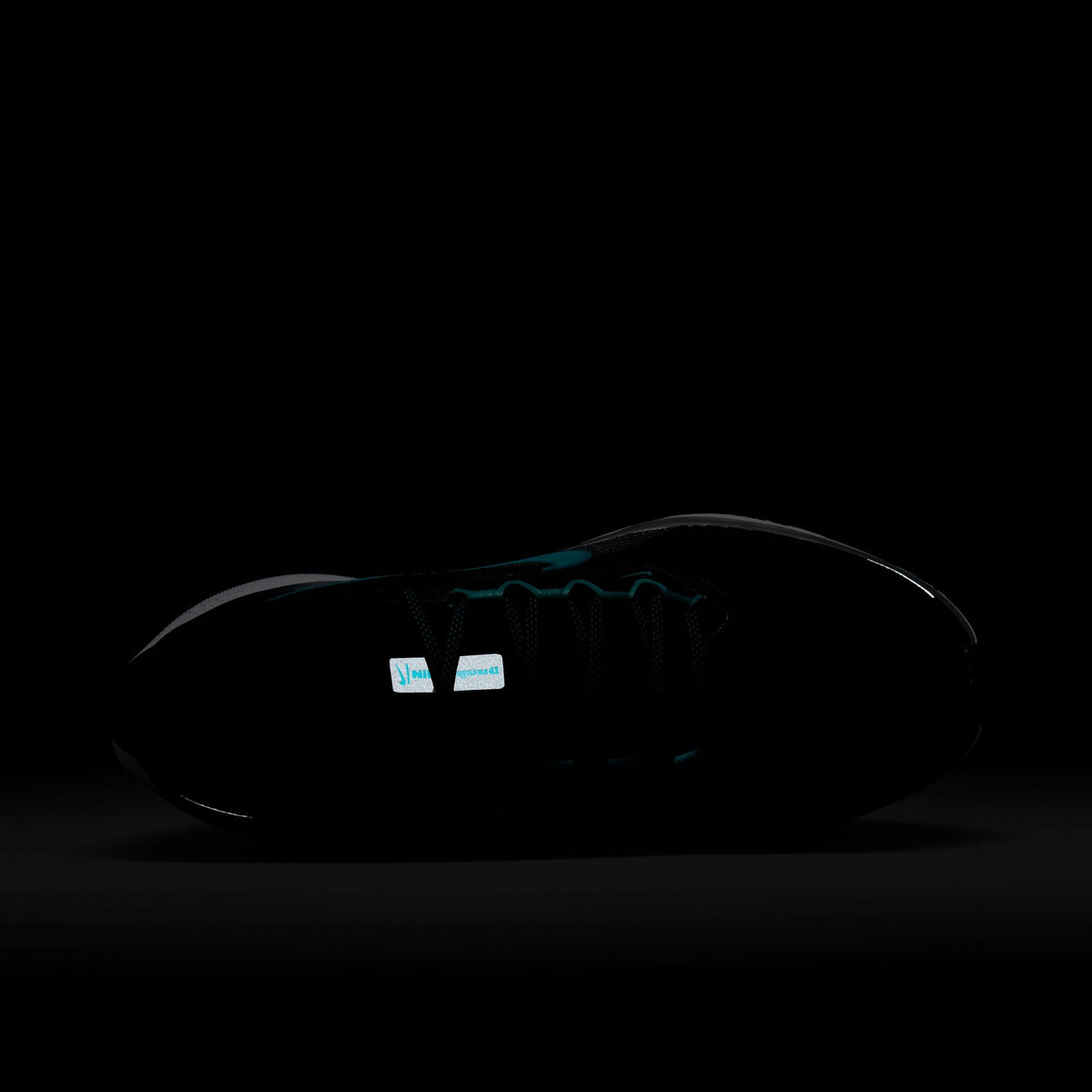 Black running shoe with low-profile upper, side logo, and Zoom Air unit