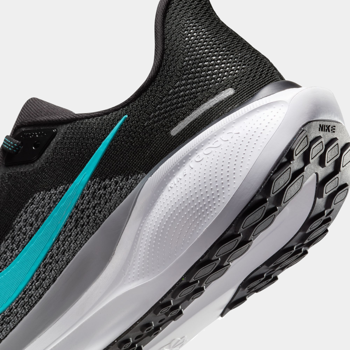 Air Zoom Pegasus 41 close-up: black mesh upper with teal stripe and tread sole