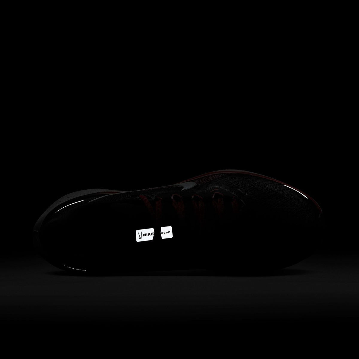 Black running shoe with Nike swoosh, visible tongue label and lace-up design