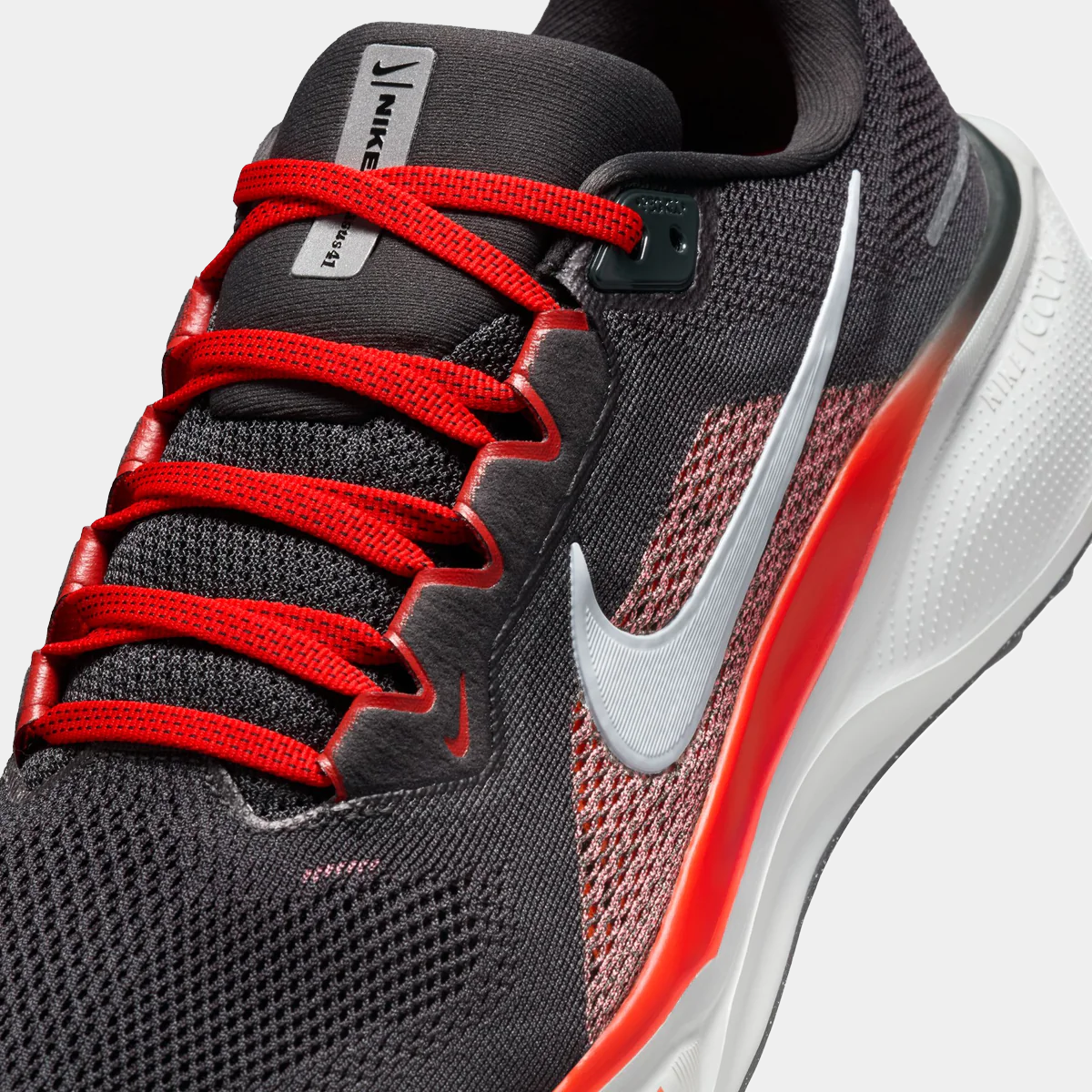 Air Zoom Pegasus 41 close-up, black tongue and laces with red lace rows and swoosh