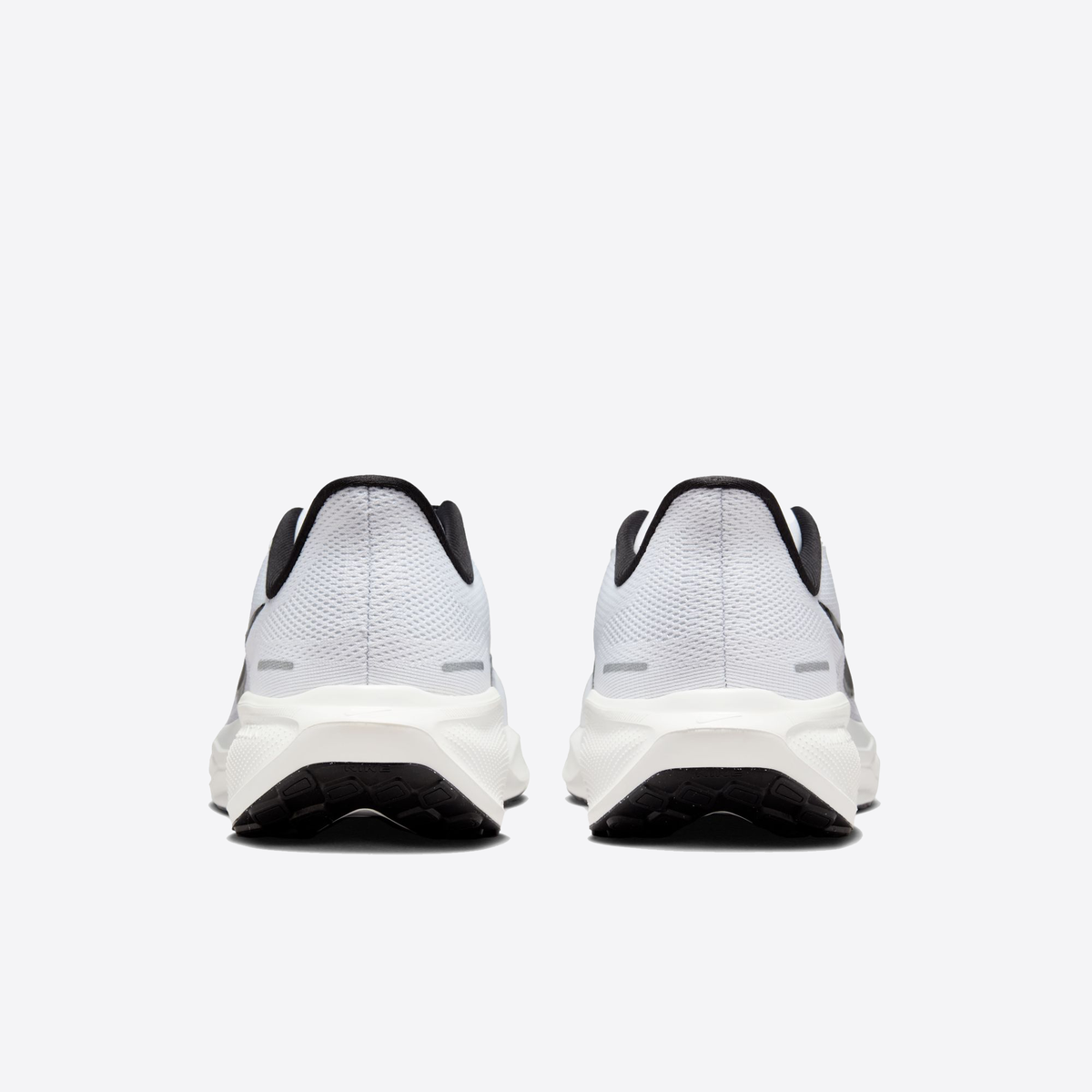 White running shoes with black accents, rear view, mesh uppers and padded heel
