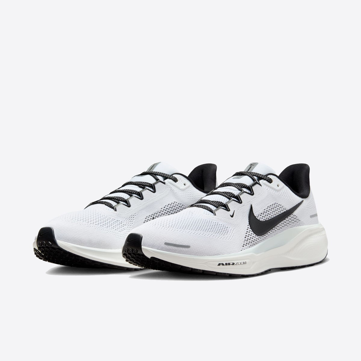 White running shoe with black Nike swoosh and dark outsole tread