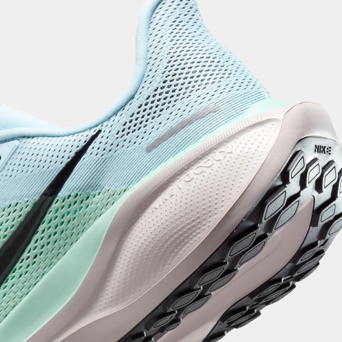 Close-up of light blue mesh upper and white midsole with textured outsole