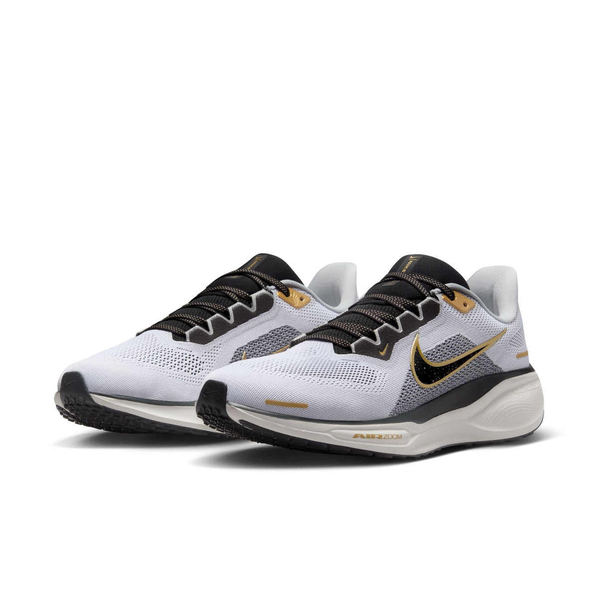 Pegasus 41 running shoes, white and dark gray knit with black laces and gold accents.