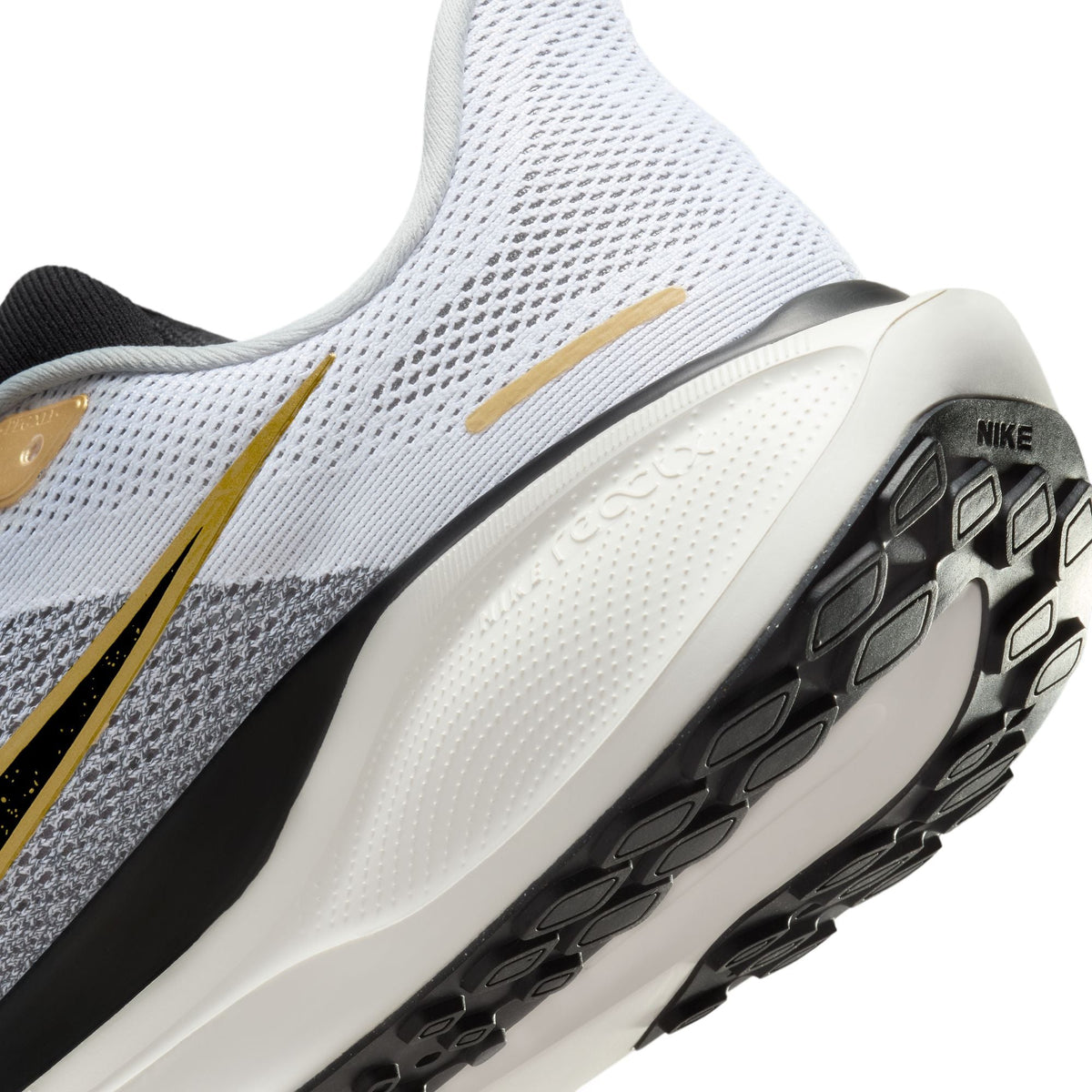 Pegasus 41 running shoes, white upper with gold accent stripe and black outsole tread.