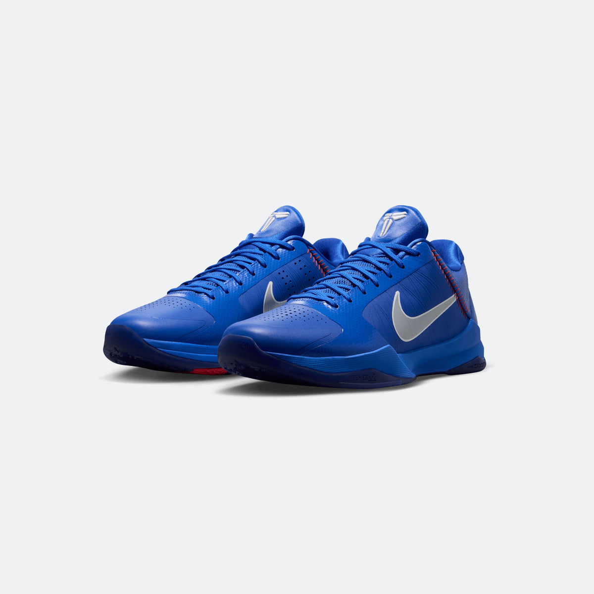 Blue Kobe V Protro basketball shoes, lace-up design with Swoosh and red accents
