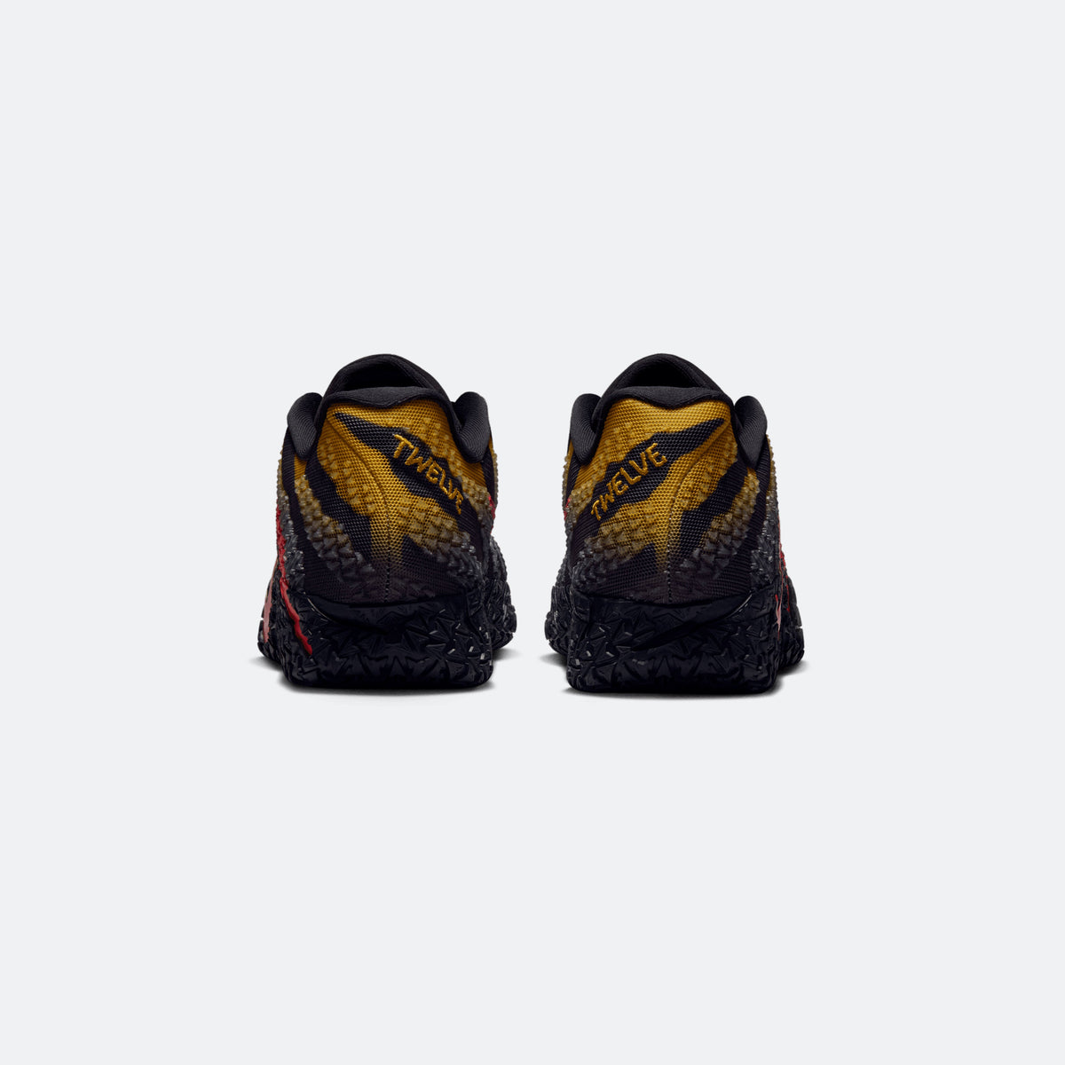 Black heel view of lace-up basketball sneakers with yellow knit panels and red accents