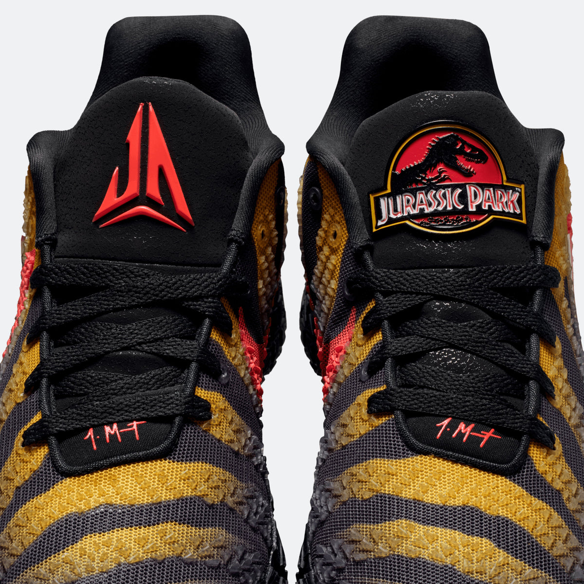 Black shoe collar with red emblem and Jurassic Park patch; lace-up basketball sneakers