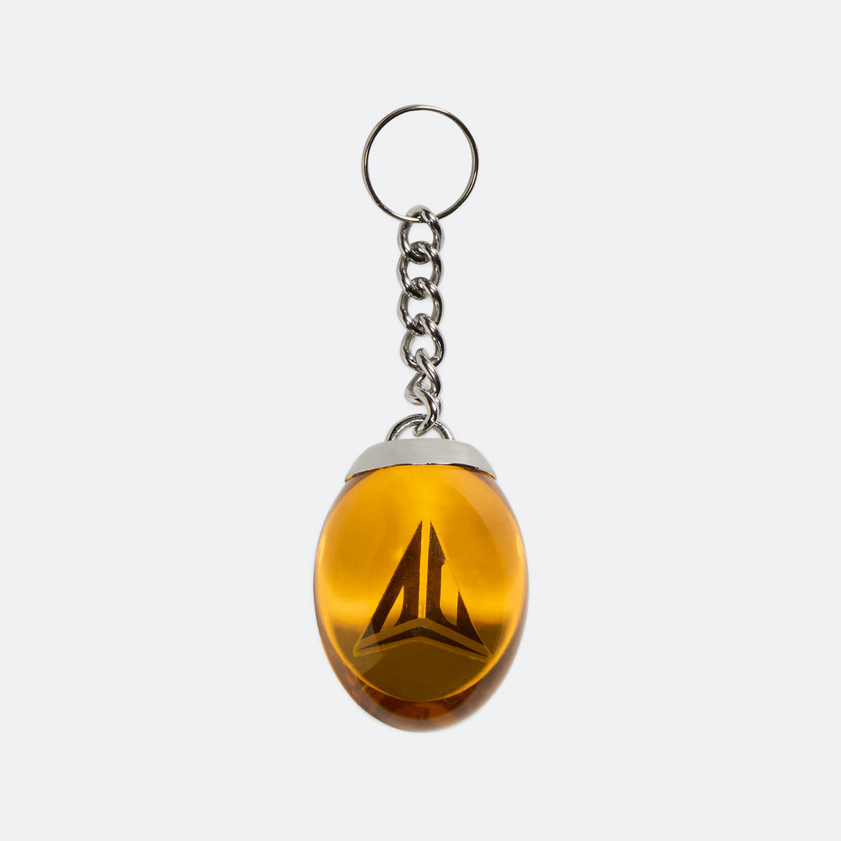 Metal keychain with gold teardrop charm featuring a red-and-black emblem
