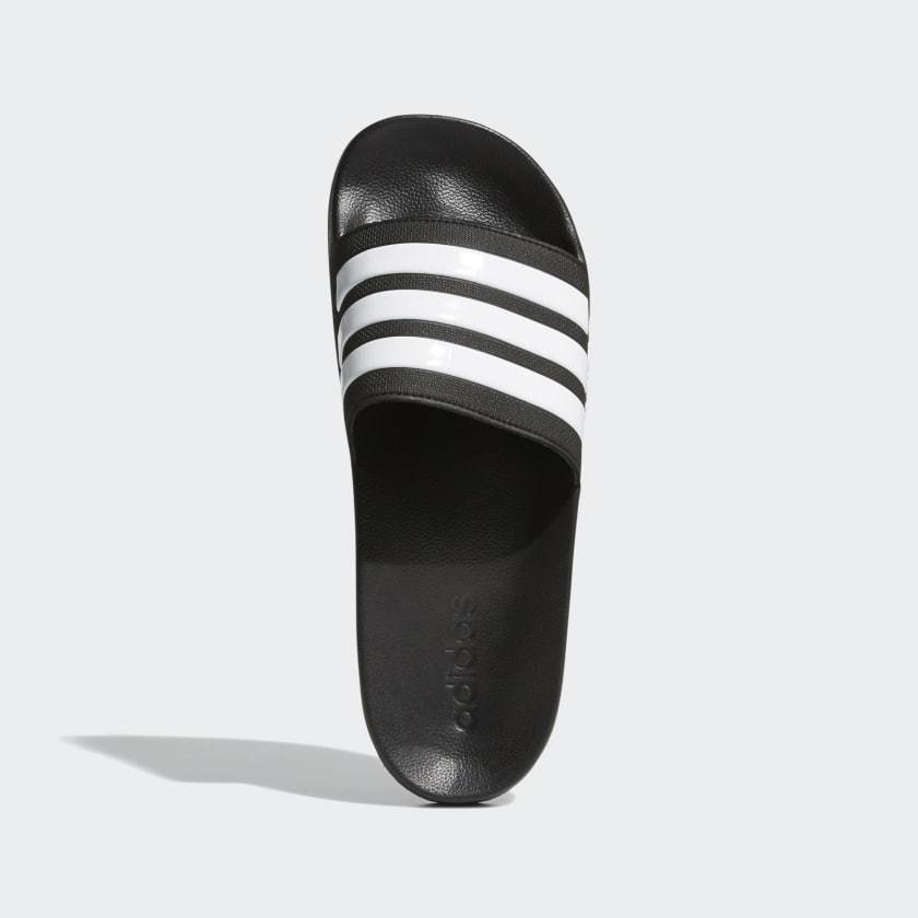 Black leather-look shower slide sandal with white triple stripes on the strap