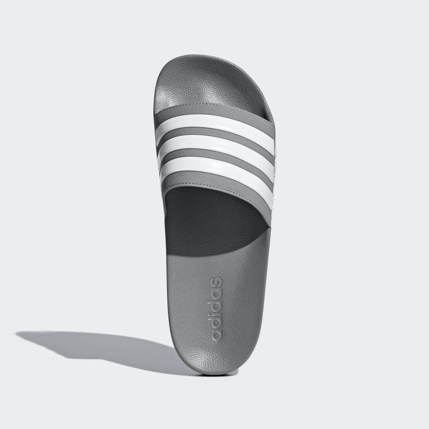 Adilette shower slides gray with three white striped bands and adidas logo