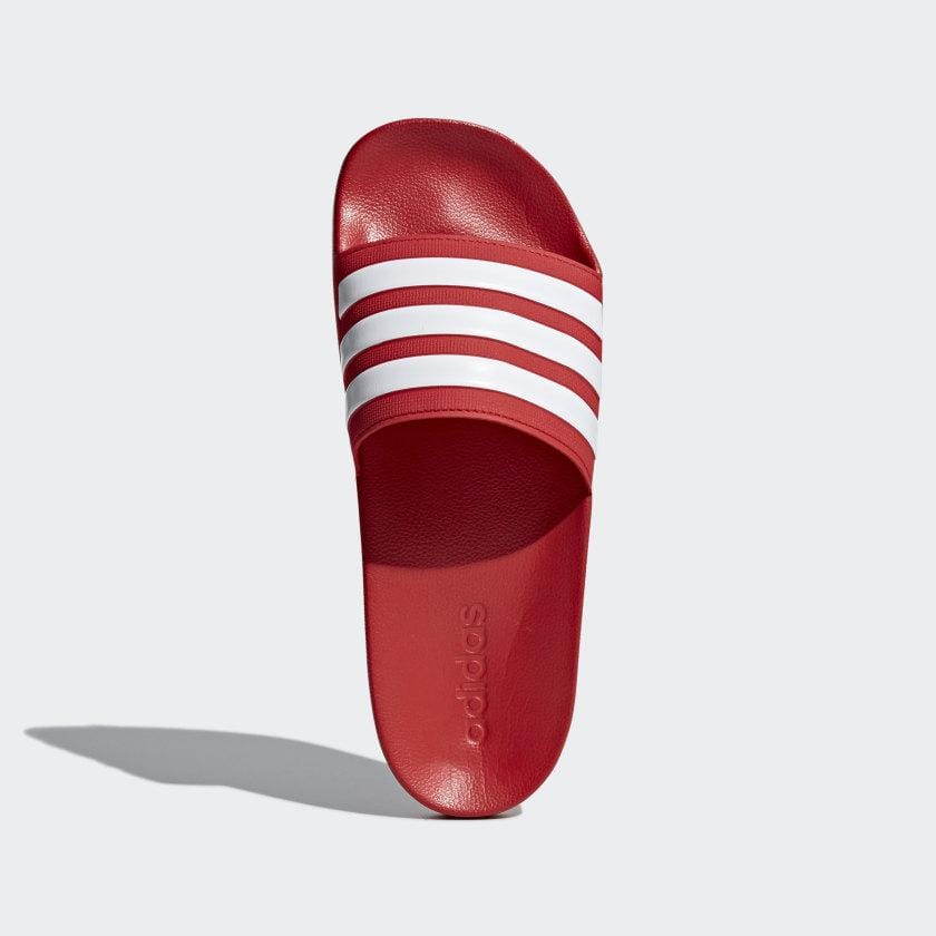 Red Adidas shower slide sandal with three white stripe bands and cushioned footbed