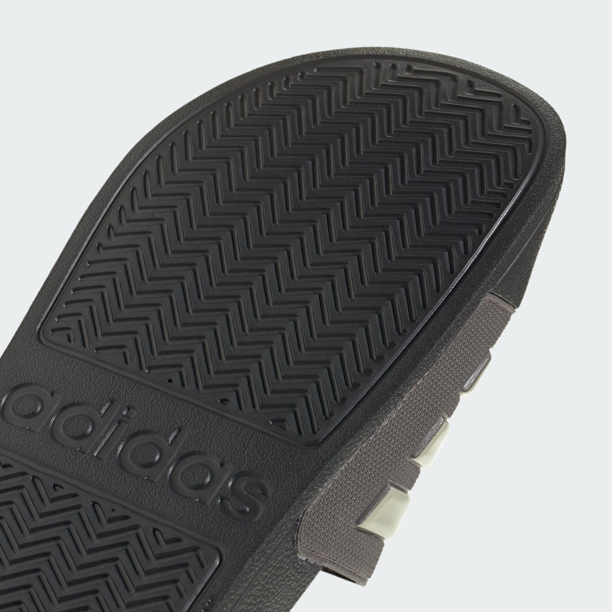 Black rubber outsole with adidas logo and zigzag tread pattern