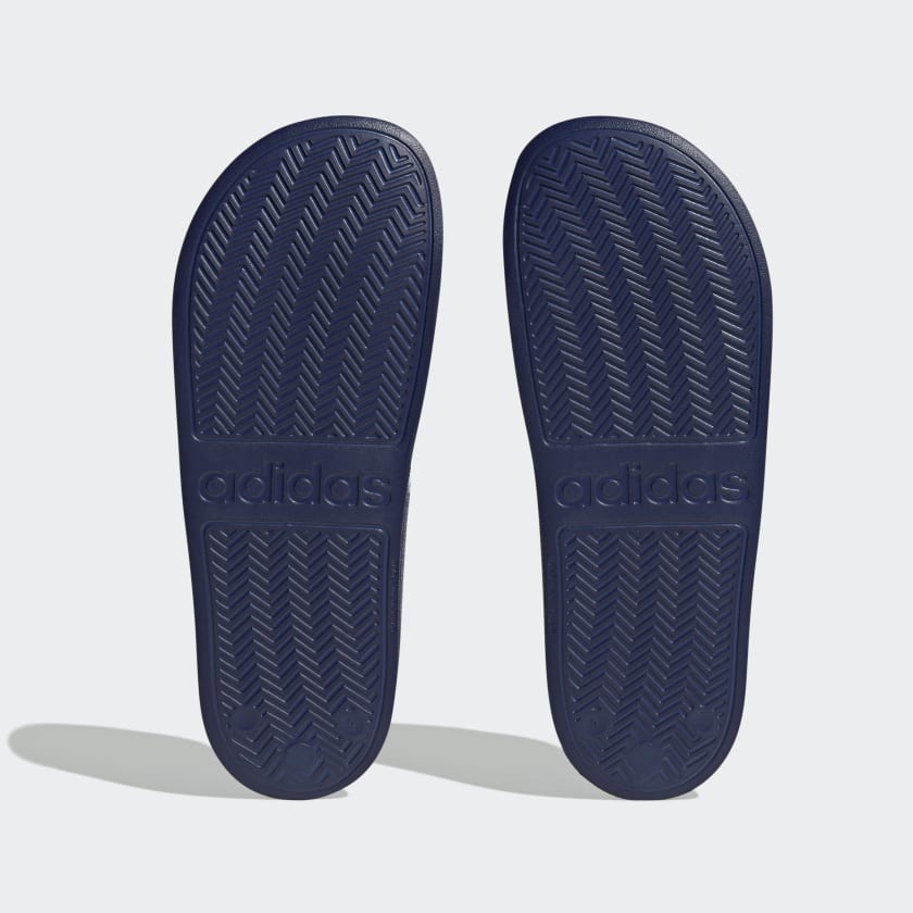 Adilette shower slides outsoles, dark blue textured tread with adidas branding