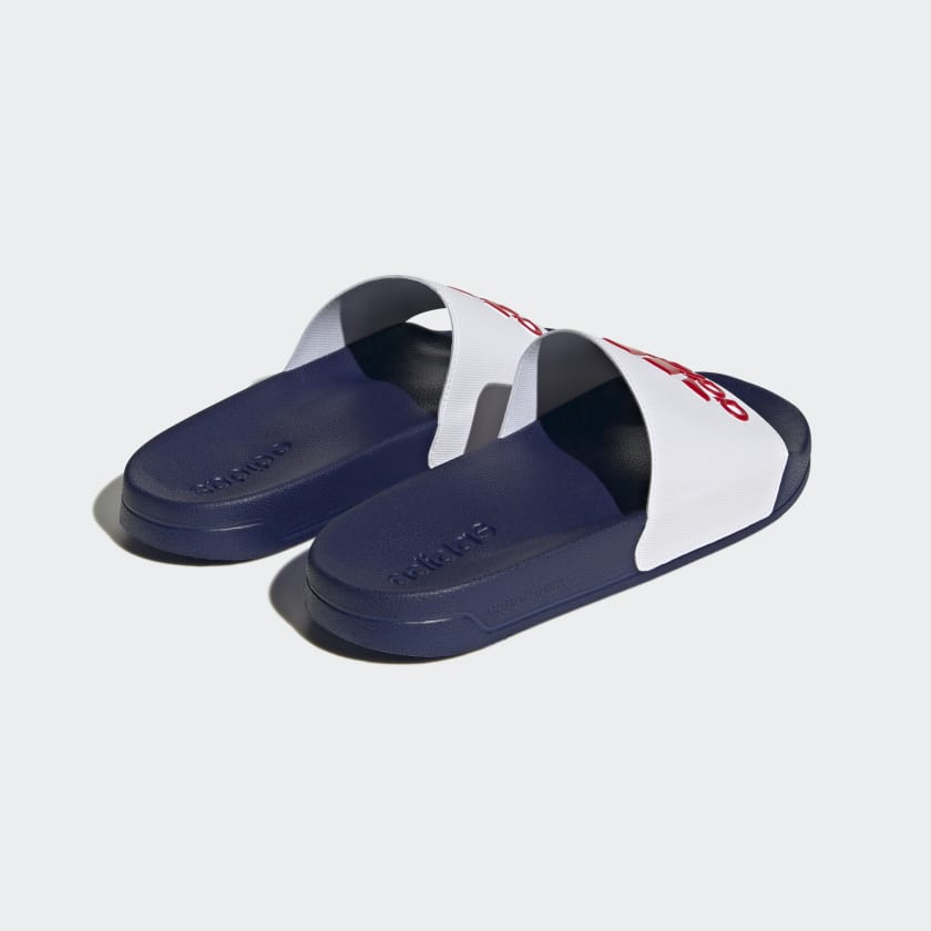 Adilette shower slides, navy base with white strap, molded footbed and adidas text