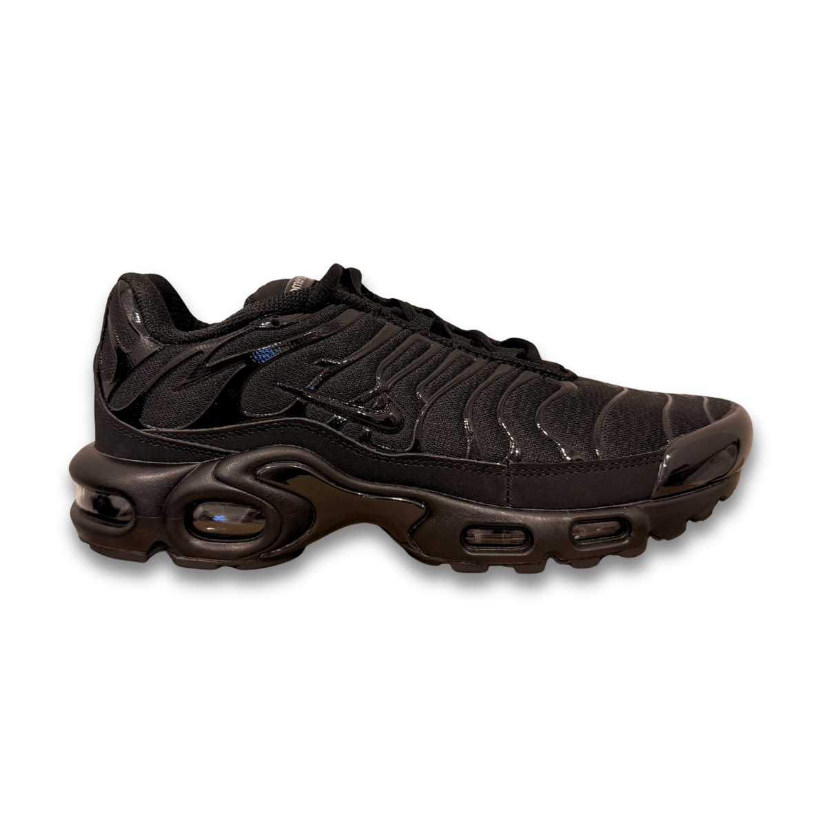 Black Nike lace-up sneaker with sculpted wavy panels and visible air cushioning sole