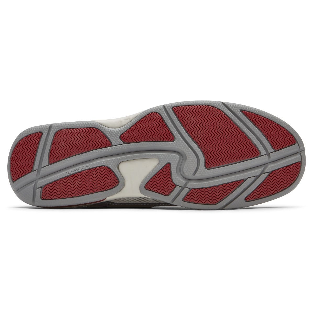 Navy boat shoe outsole with gray tread and red patterned traction inserts