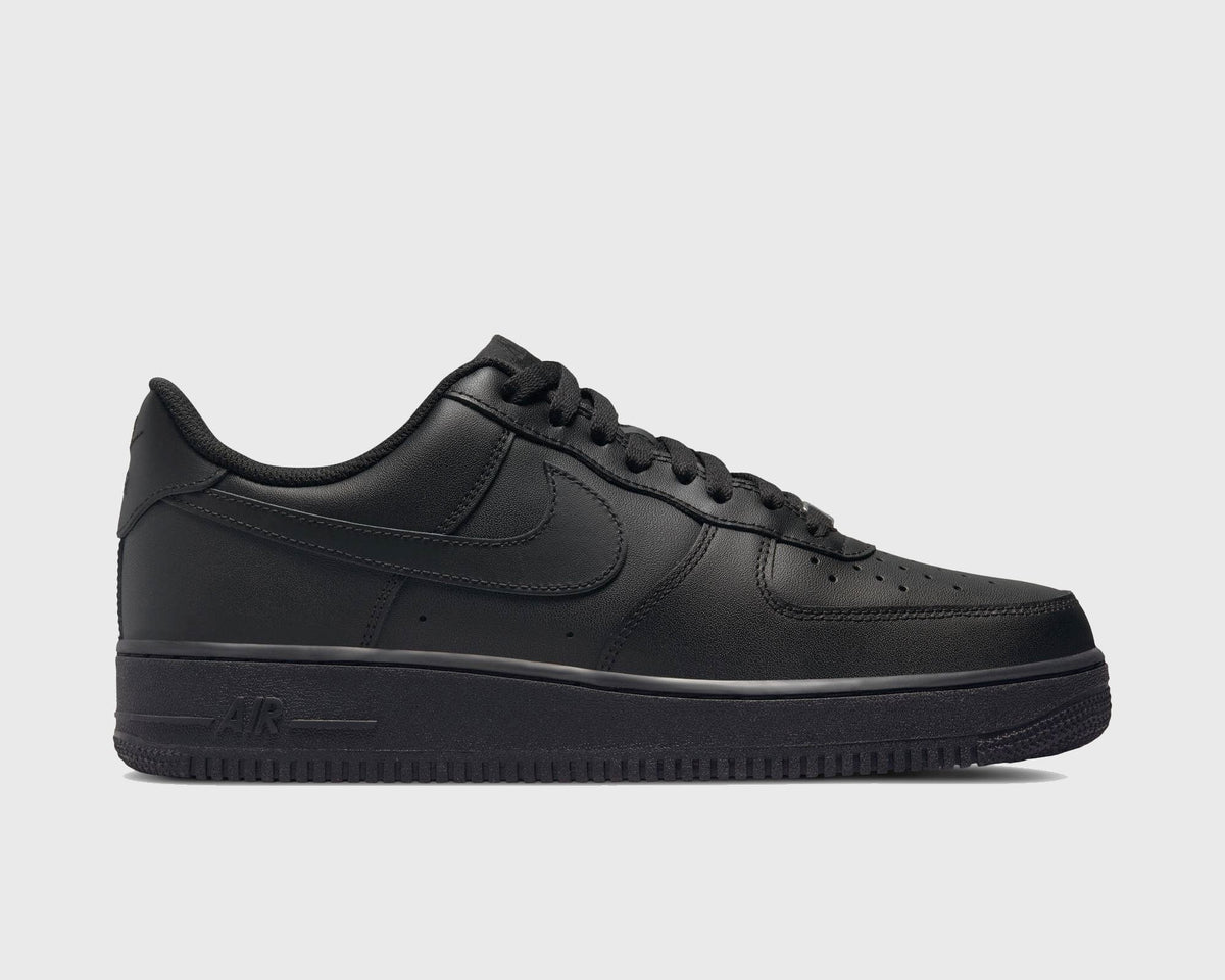 Black low-top sneakers with lace-up closure and Air logo on midsole