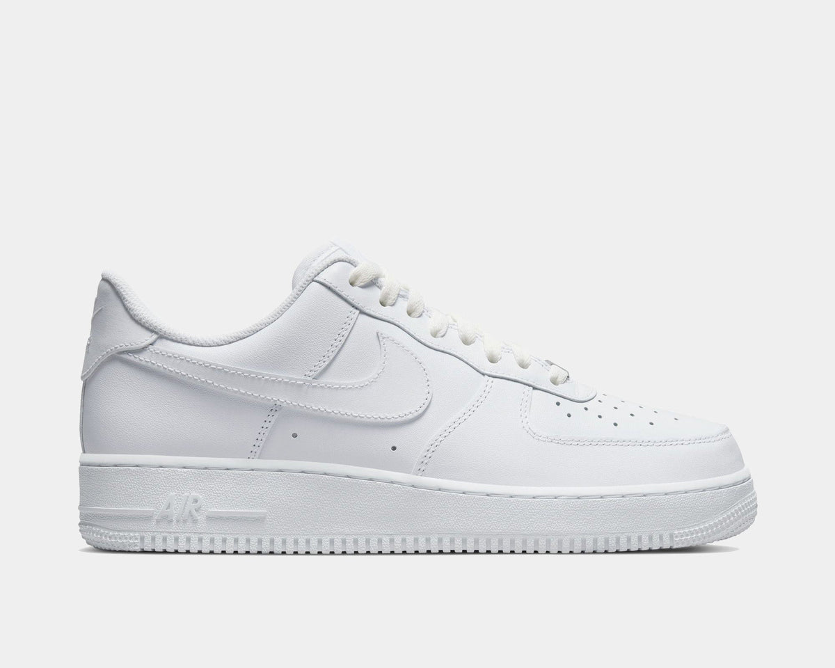White leather low-top sneakers with Nike swoosh and lace-up front