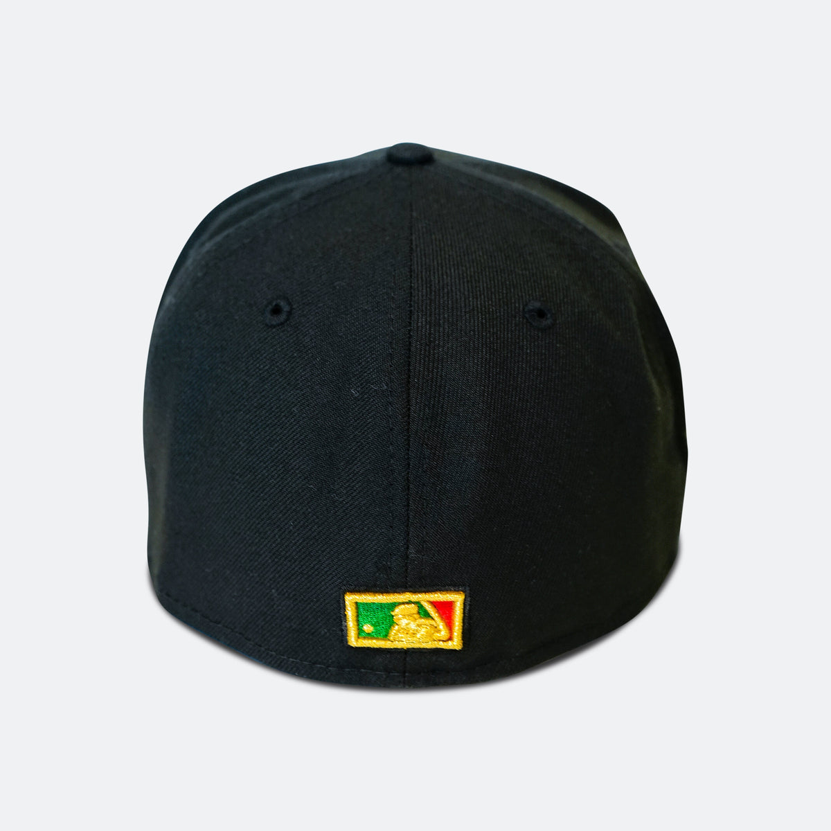 Black baseball cap with small rectangular green-and-red patch on front