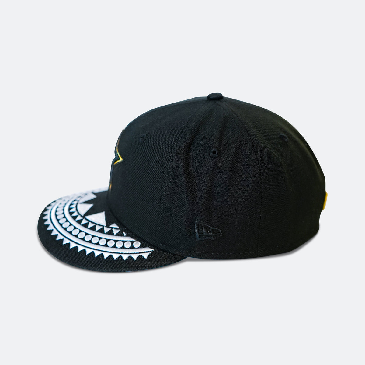 Black baseball cap with white patterned brim and New Era logo on side