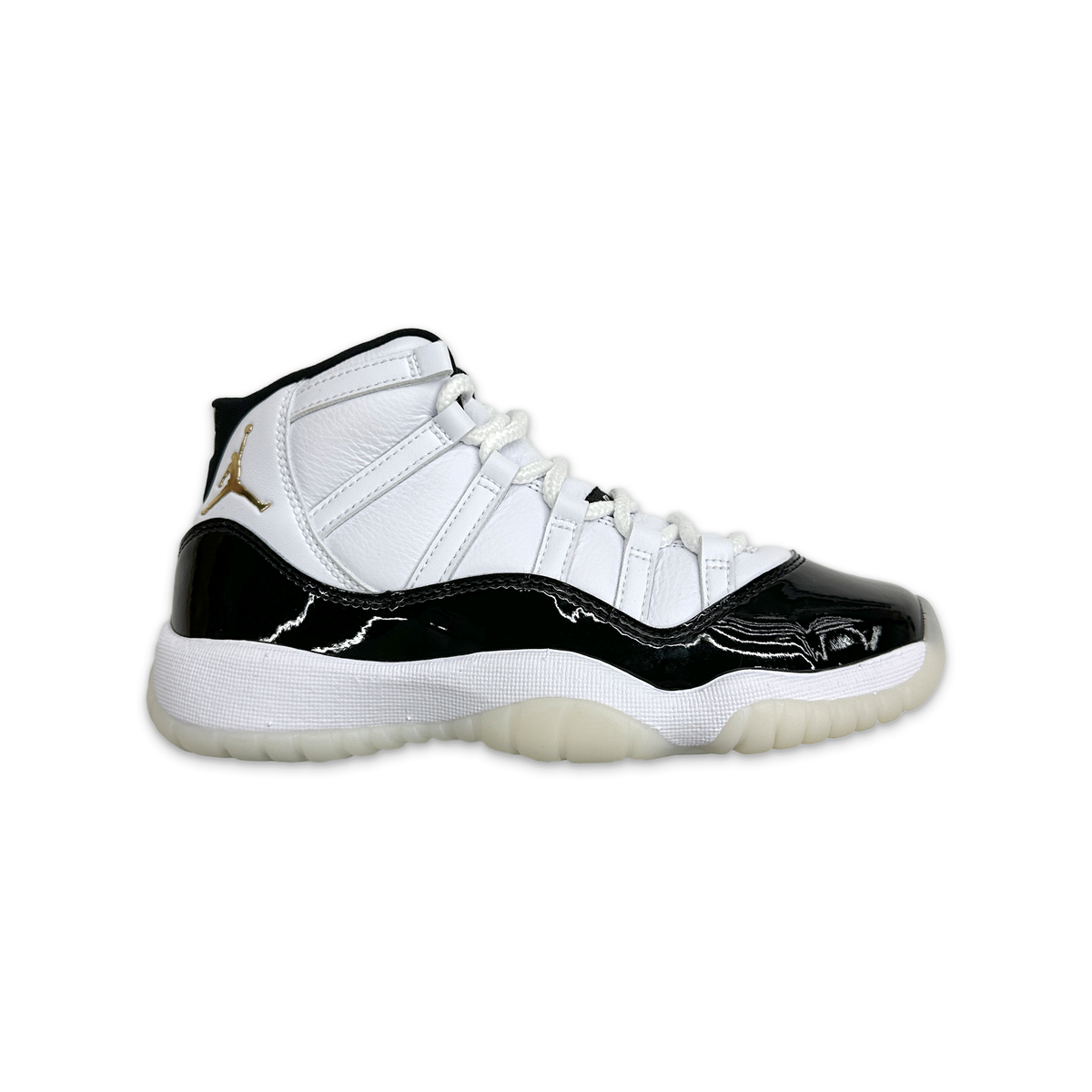 Kids Air Jordan 11 Retro sneaker, white leather with black patent mudguard and gold logo