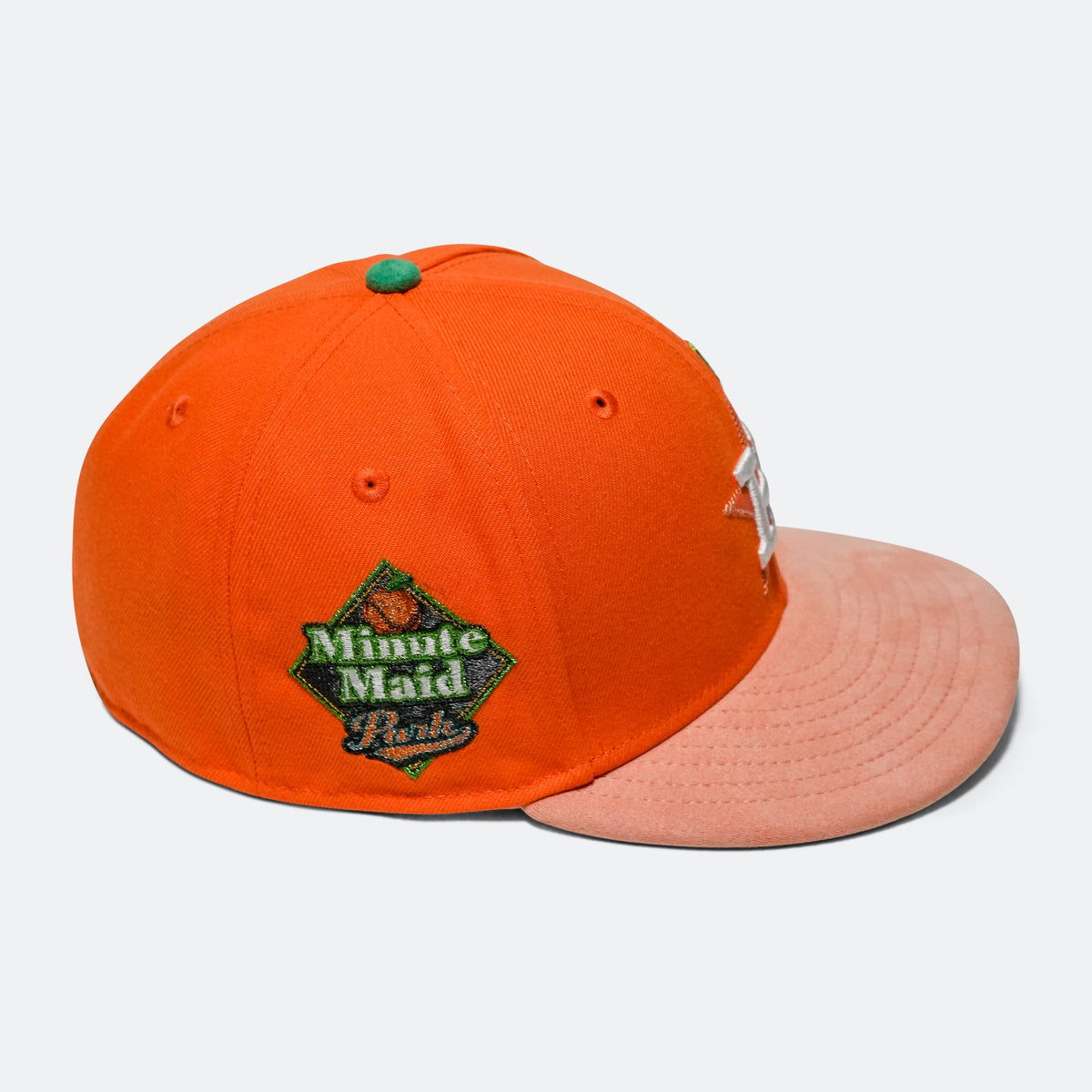 Orange baseball cap with pink brim and green 'Minute Maid Park' patch, silver 'H' logo