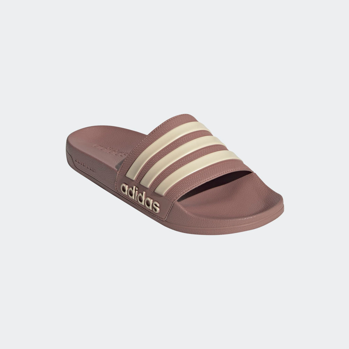 Rose-brown shower slide sandals with adidas logo and three cream stripes