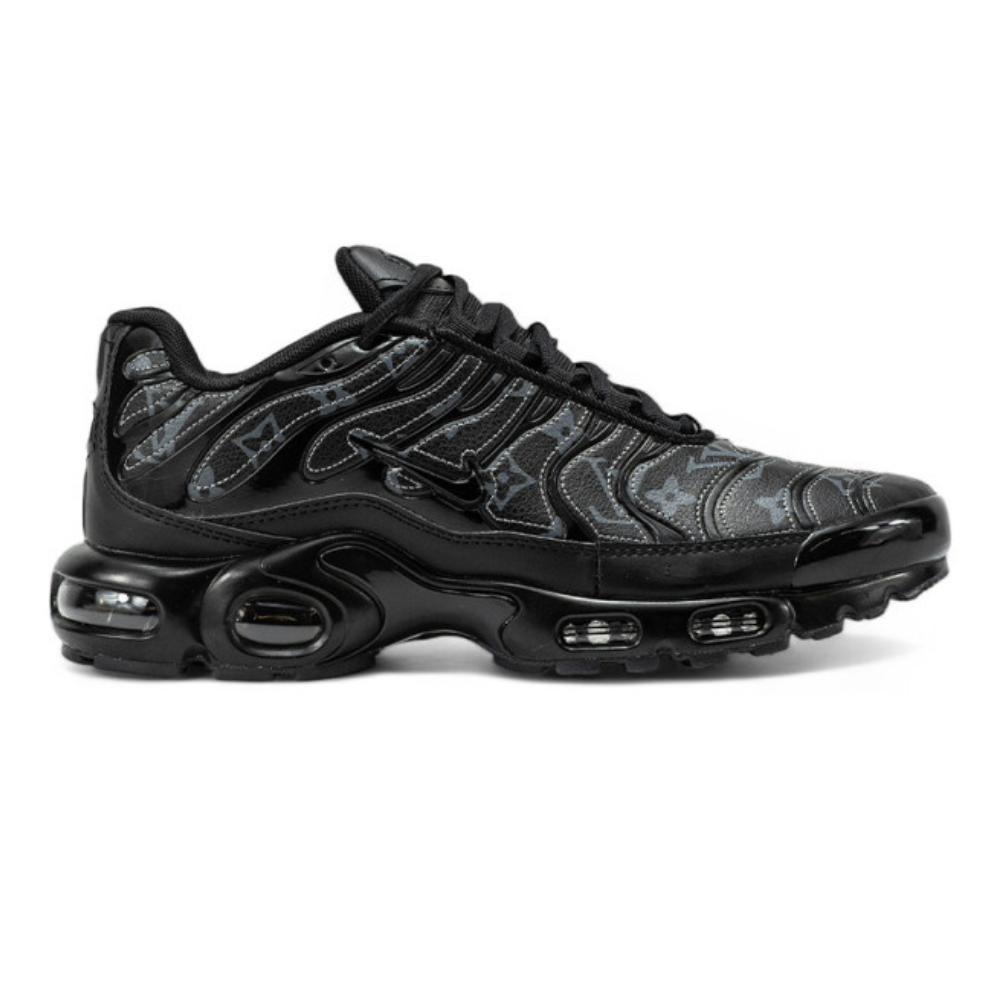 Black athletic sneaker with air-cushioned sole and metallic logo accents