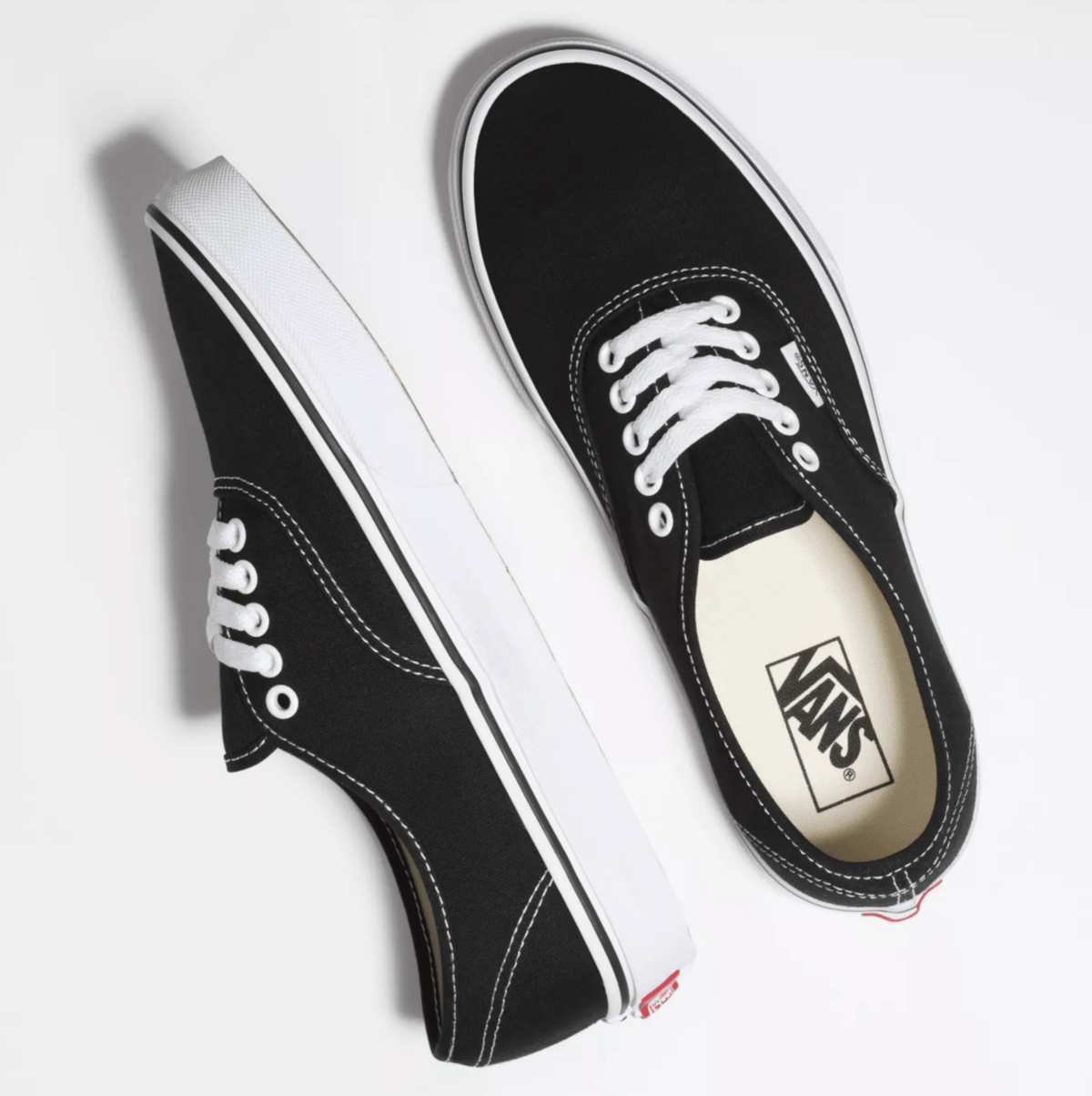 Black canvas sneakers with white laces and Vans logo patch on tongue