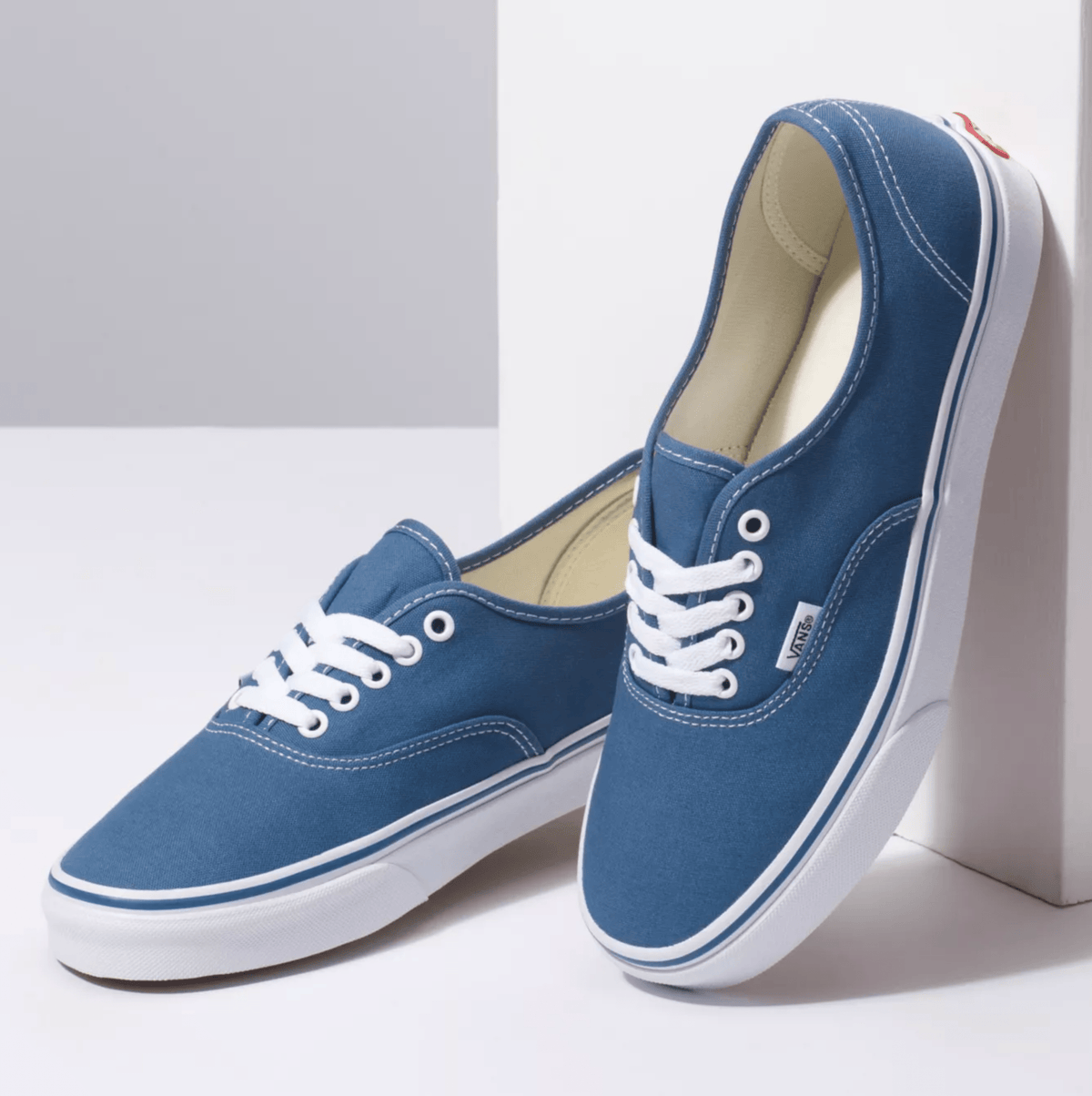 Navy canvas low-top sneakers, one pair with visible heel and sidewall stitching