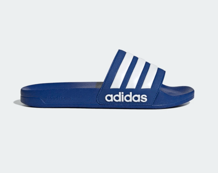 Blue Adilette shower slide sandals with white triple stripes worn