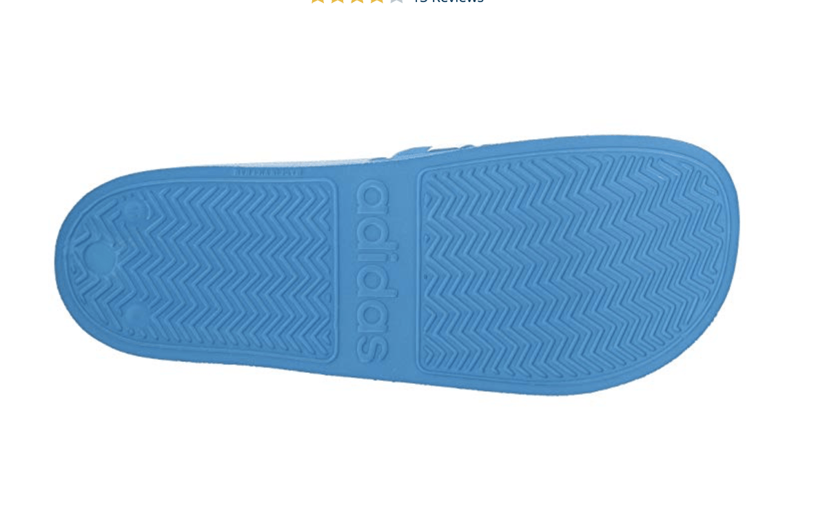 Blue Adilette shower slide sandal outsole with textured tread pattern