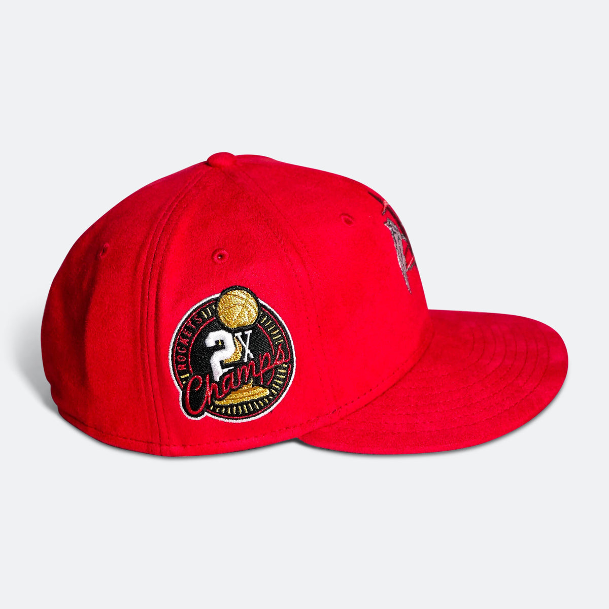 Red baseball cap with embroidered circular Champion-style patch on side